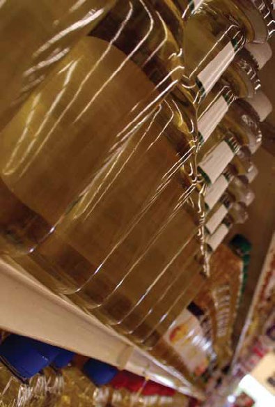 Close-up of shrink-wrapped goods stacked on a supermarket shelf