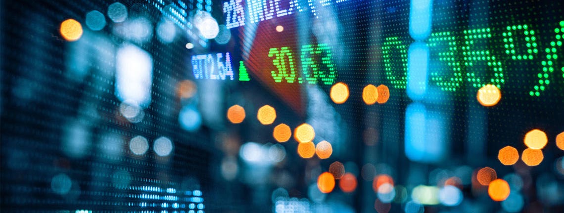 A financial market display board showing prices and percentage changes in green and red