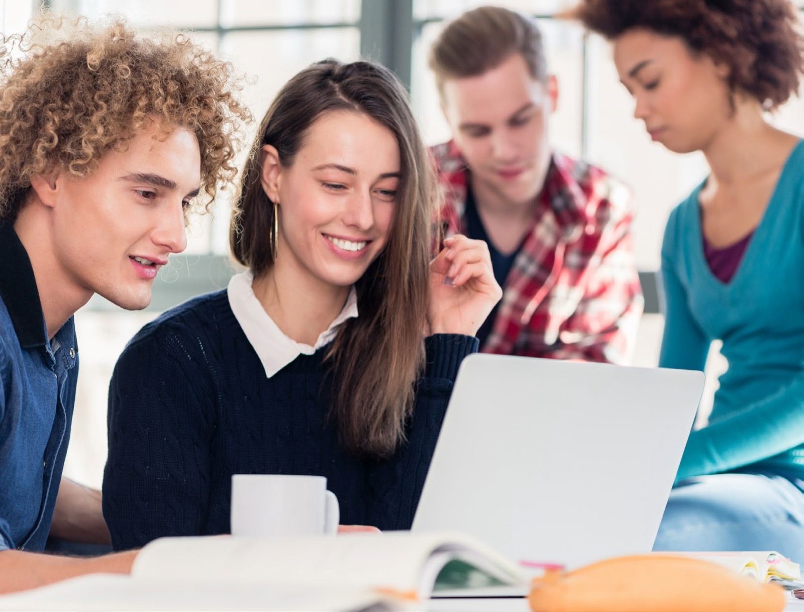 Students working together around a laptop, the classroom setting Varitronics equips
