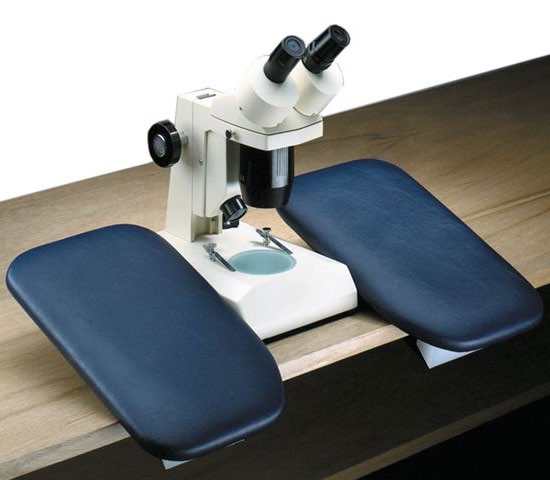 A pair of padded arm supports on a bench either side of a microscope