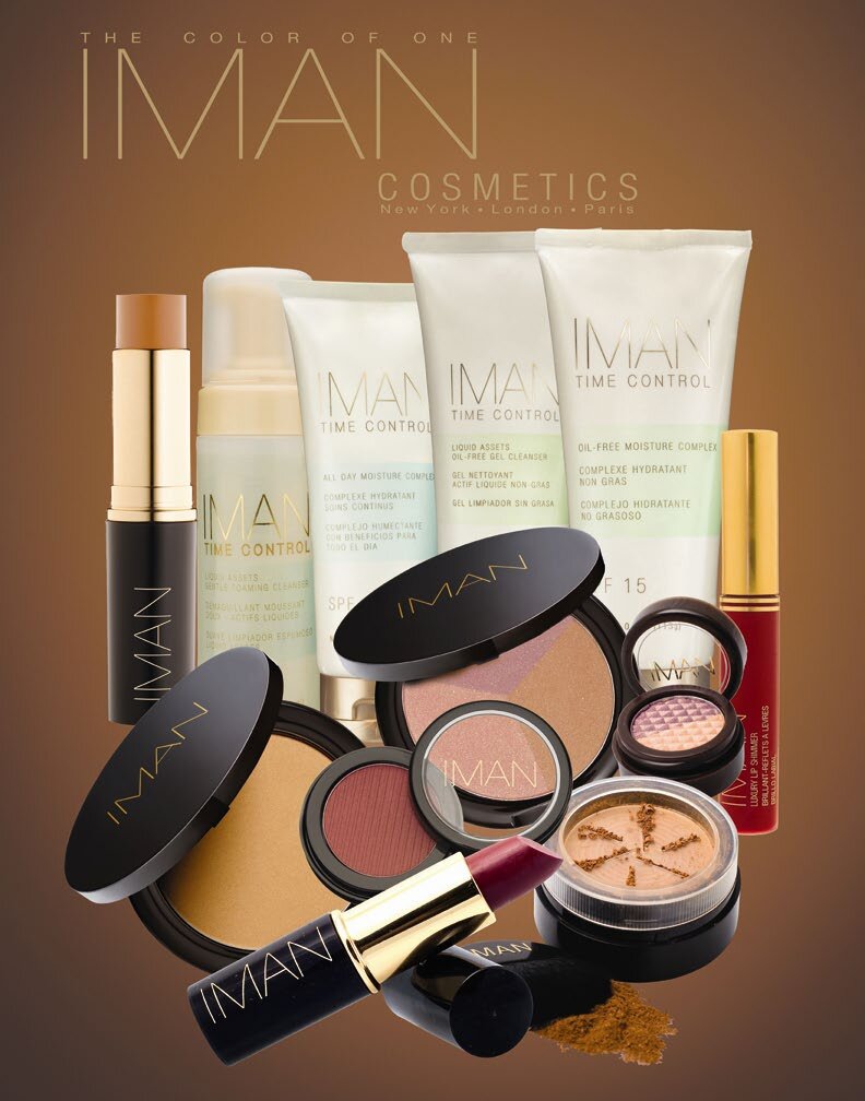 The IMAN Cosmetics range: foundations, Time Control skincare tubes, compacts and a lipstick on a bronze background