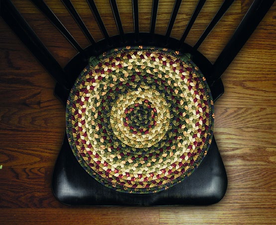 A round braided chair pad resting on a dark wooden dining chair