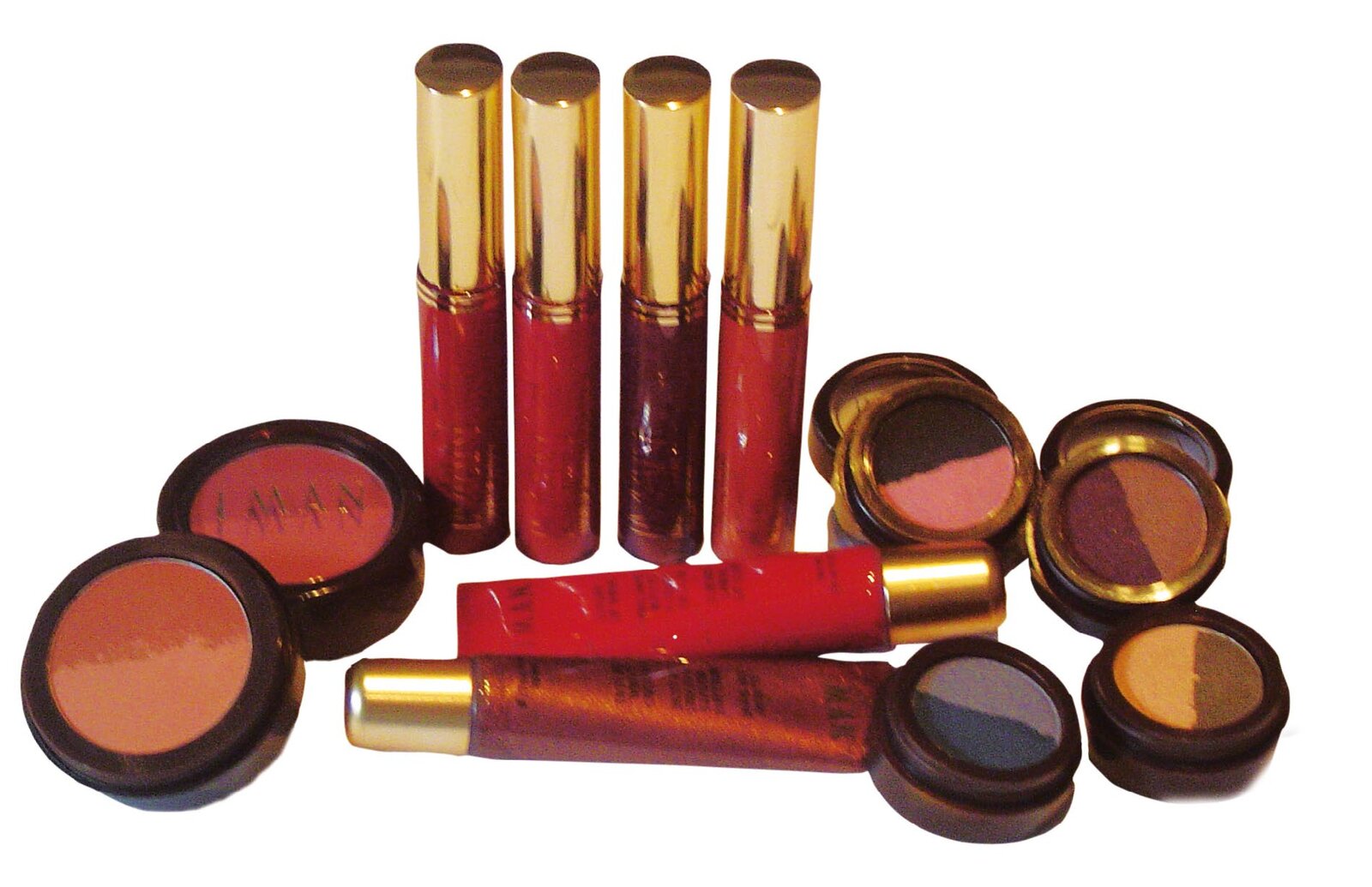 IMAN lipsticks and eye shadow palettes in red, bronze and plum tones