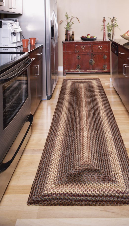 A long braided runner rug down the length of a kitchen floor