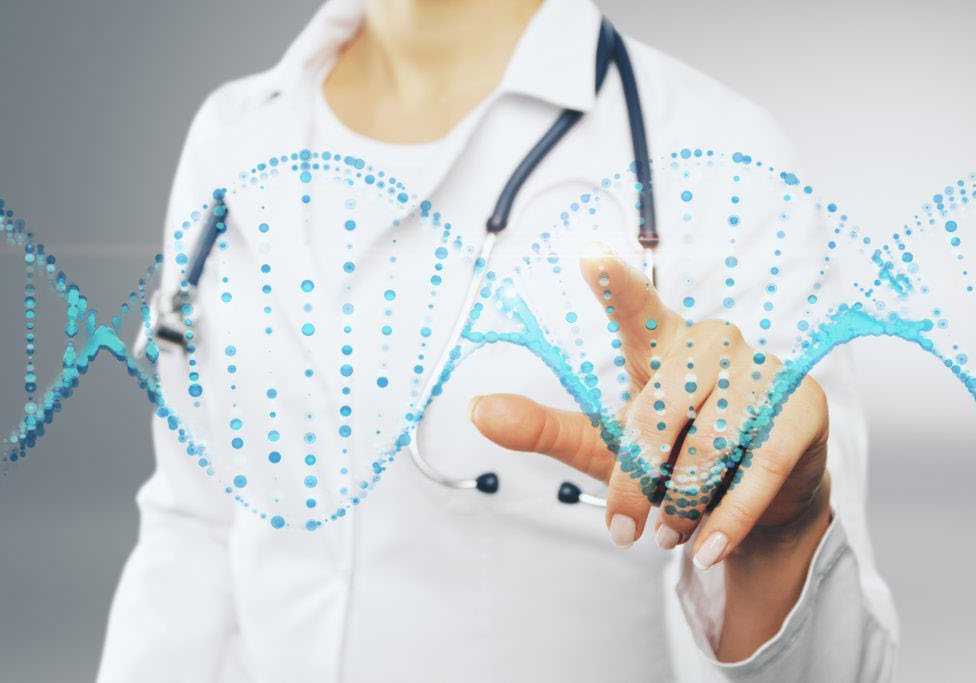 A researcher in a white coat interacting with a DNA sequence visualisation