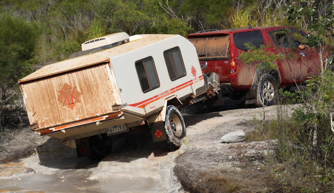 A four-wheel drive towing a Kimberley camper trailer over rocky ground